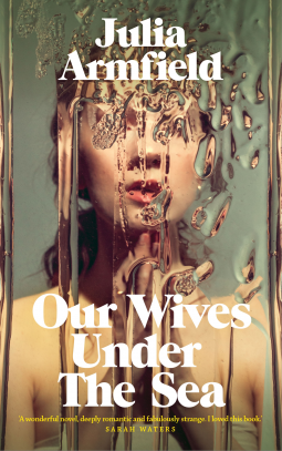 Cover of the book Our Wives Under the Sea; A woman standing in front of a mirror, water obscures her face. 