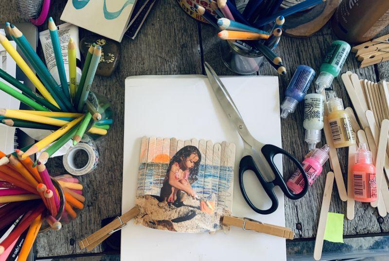 Photo of popsicle stick frames Craft in progress surrounded by art supplies